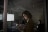 Businesswoman using digital tablet dark conference room meeting