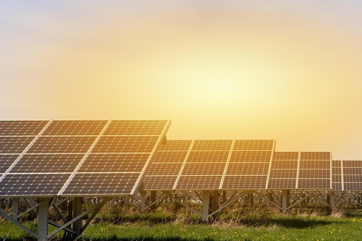 Solar panels in front of a sunset