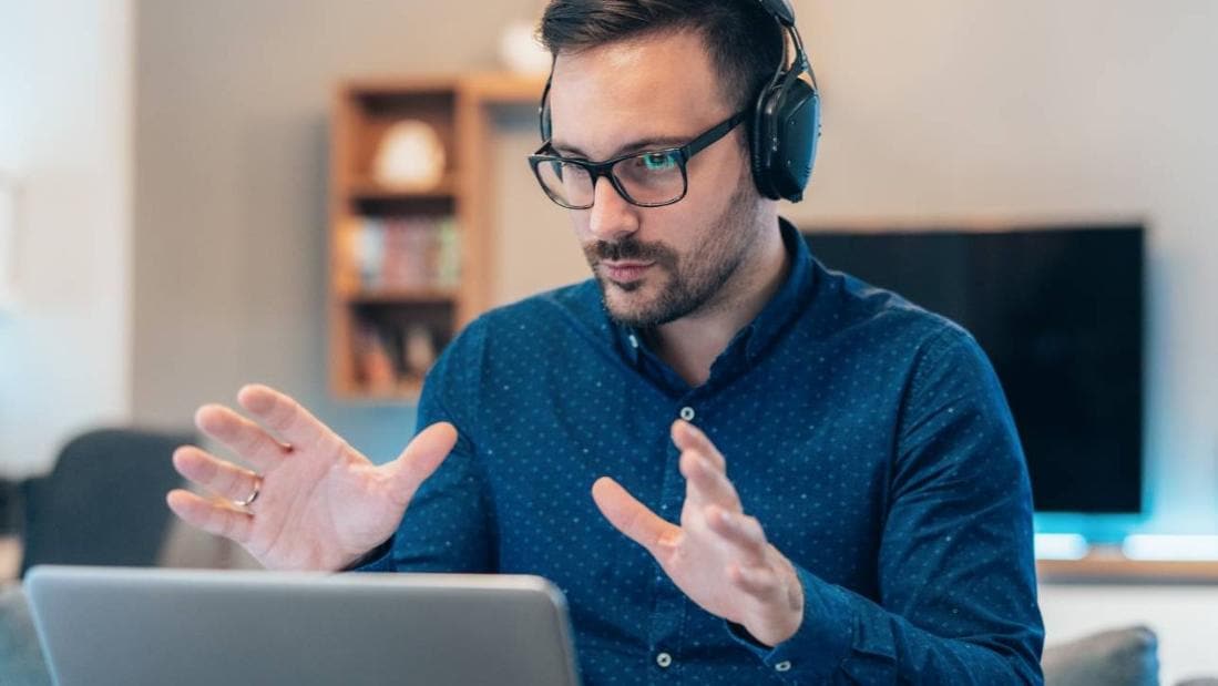 Man in blue shirt on conference call
