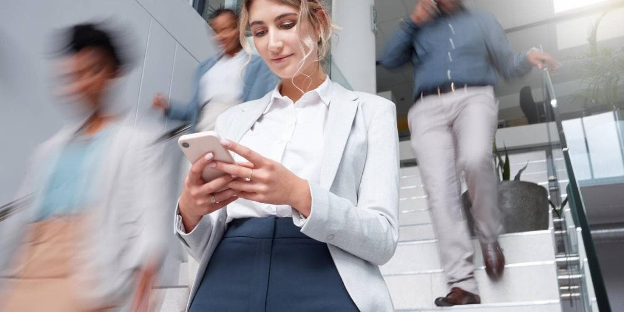 AI in Telecom & Media Woman looking down at mobile phone