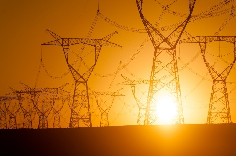 Sun behind electrical towers Sun behind electrical towers