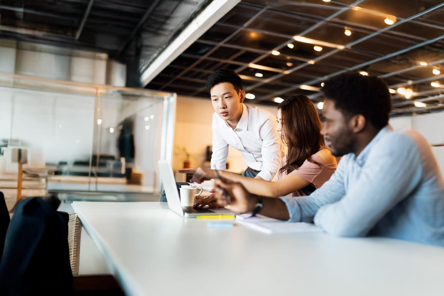 Man holding glasses and looking upward
