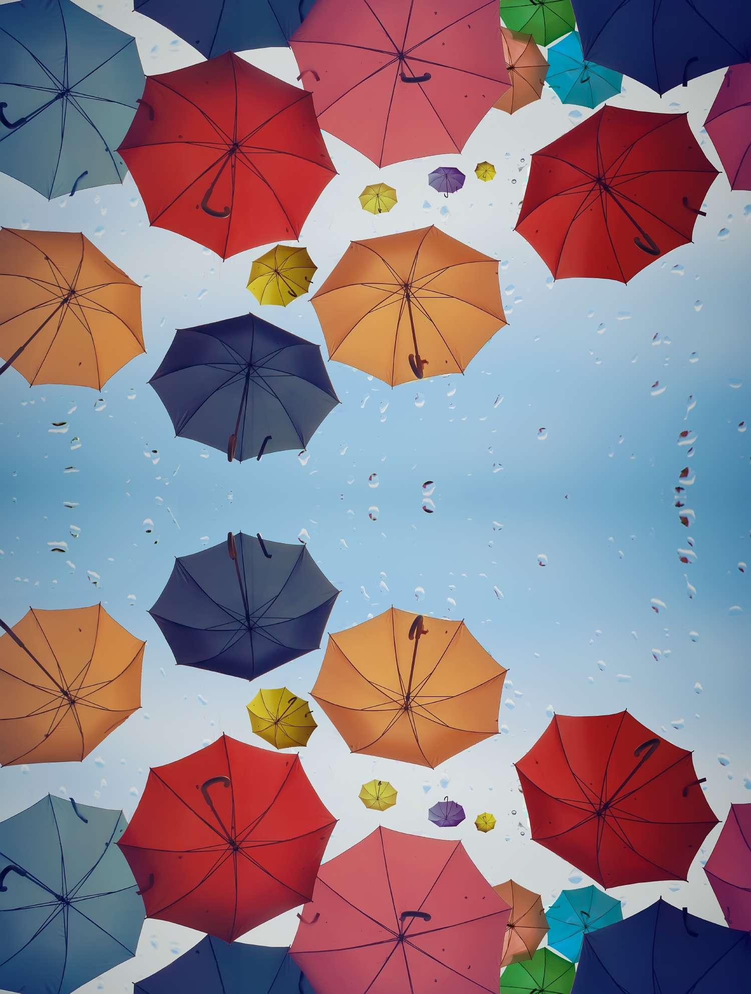Colorful umbrellas floating in the air on a rainy day