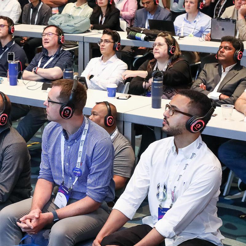 SAS Innovate attendees wearing headphones