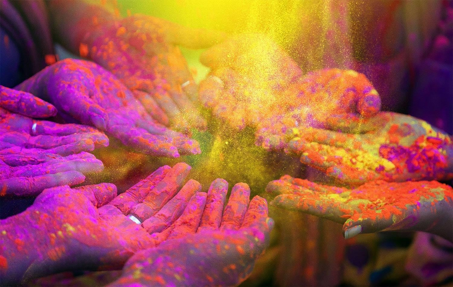 Hands in circle with colorful holi powder