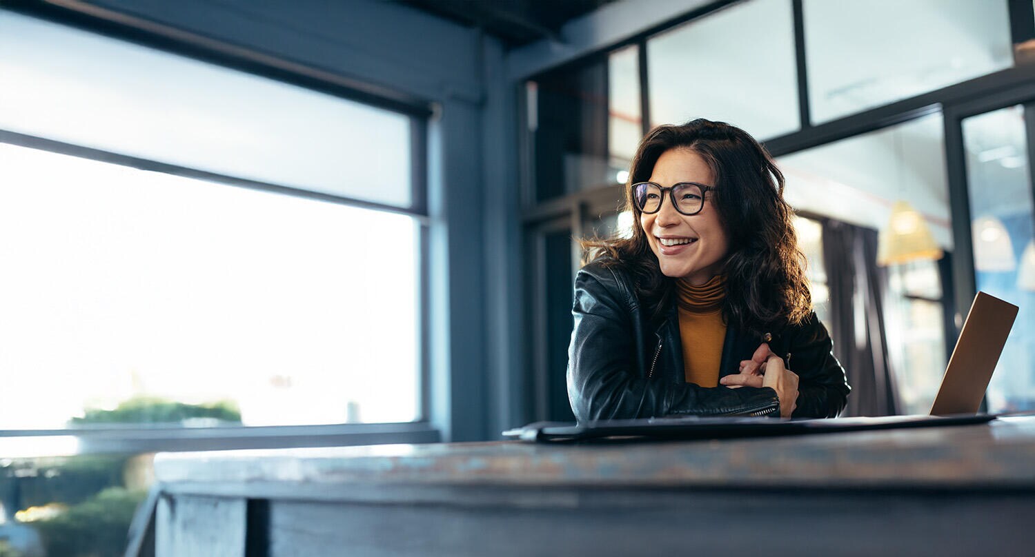 Smiling businesswoman at her computer Smiling businesswoman at her computer