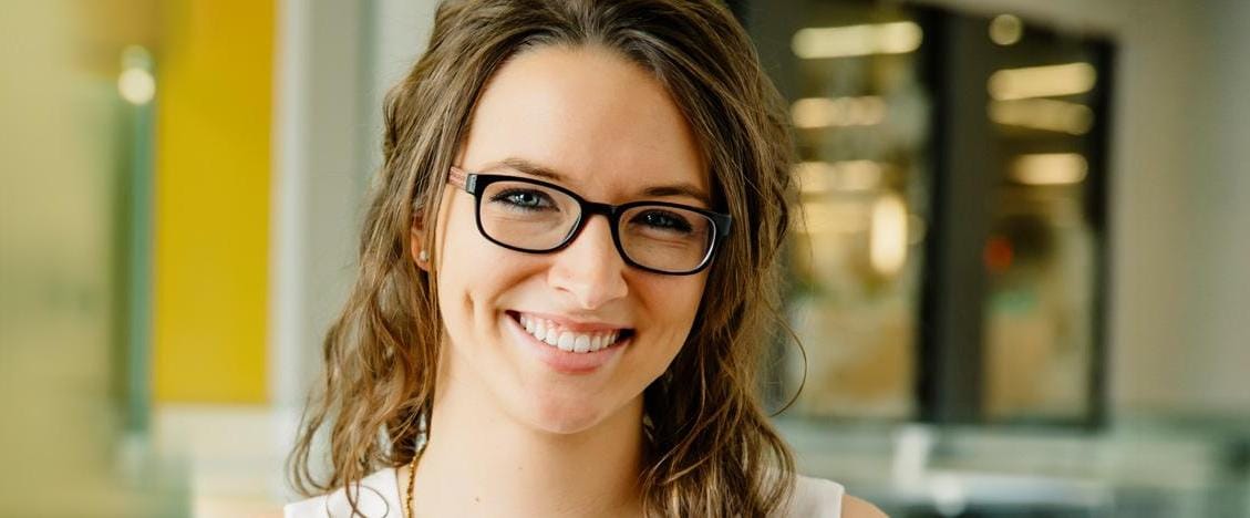 Young woman with glasses smiling