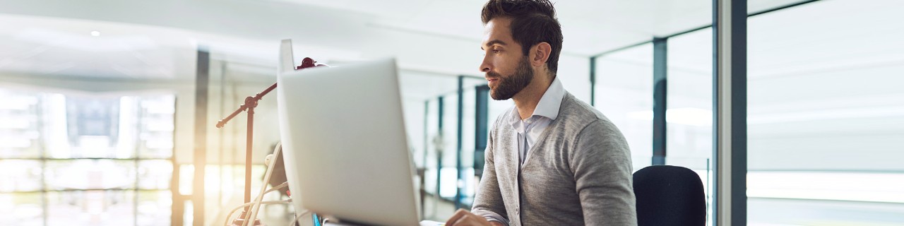 Young business man at desktop computer