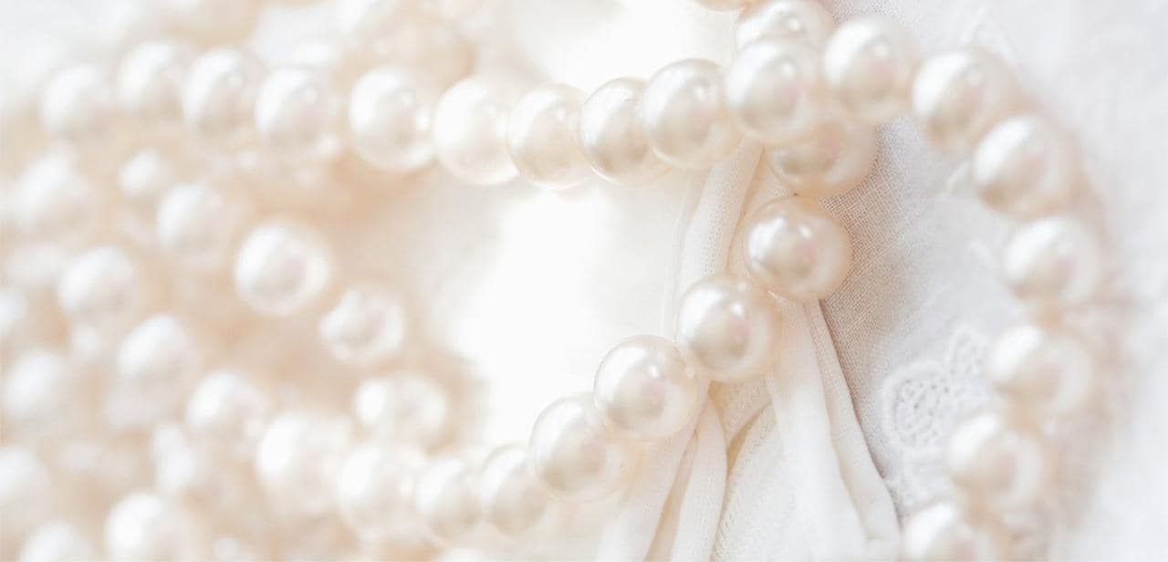 Strand of pearls on white background