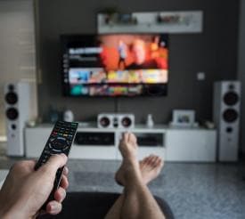 person watching TV on couch