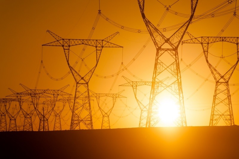 Sun behind electrical towers