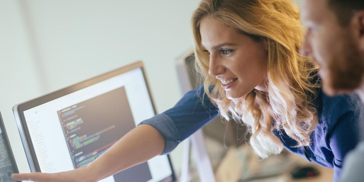 Man Working on Computer and woman pointing on screen