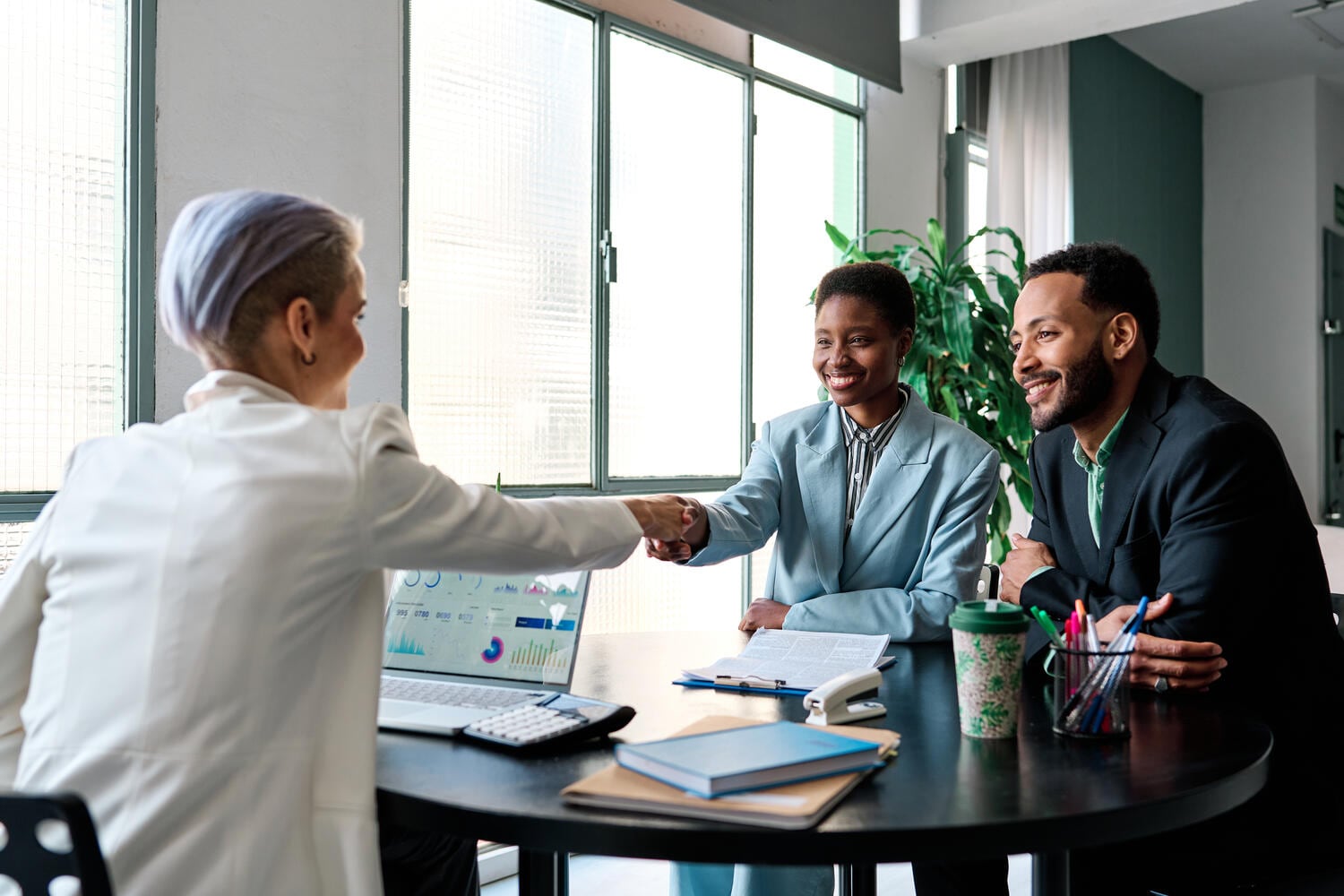 People sitting at desk and smiling