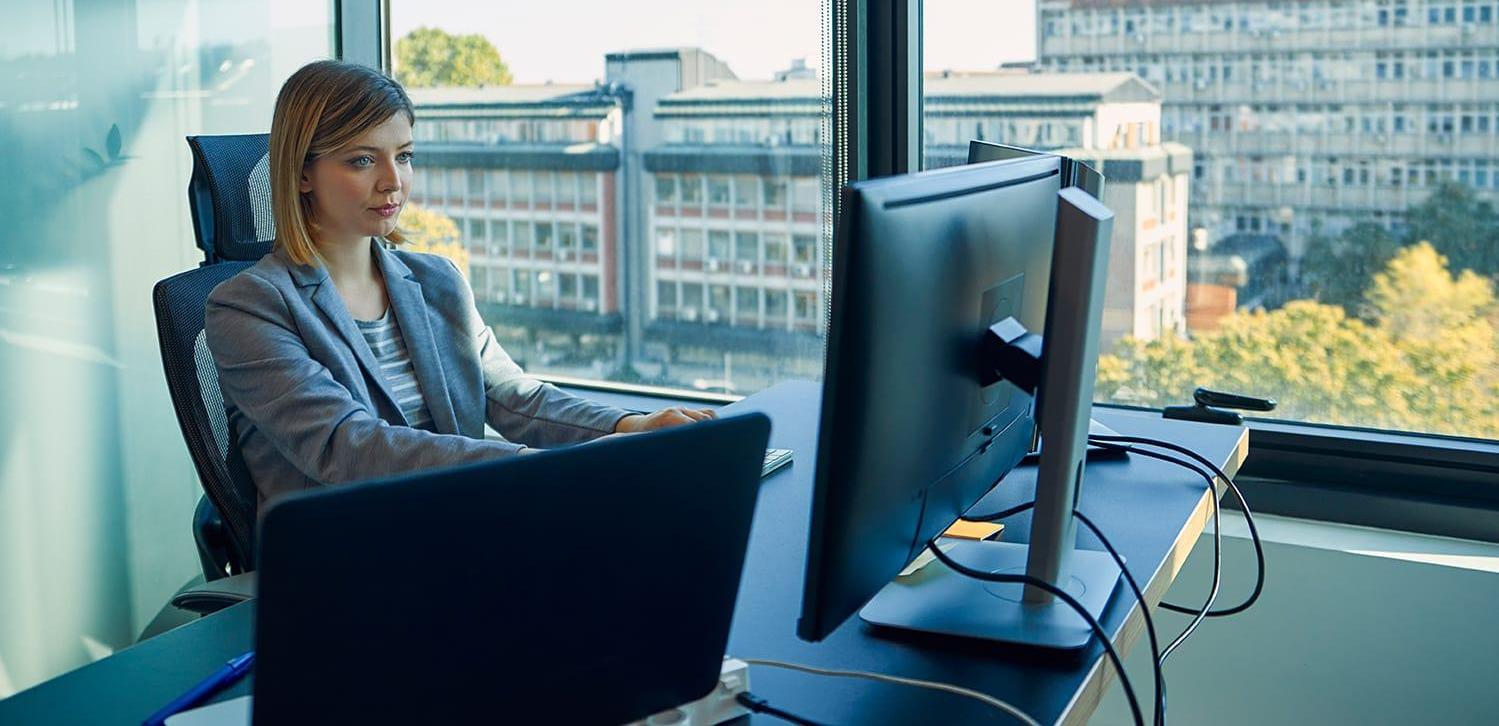 Businesswoman using computer in window office