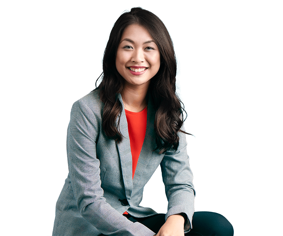 Woman in gray suit and red top sitting