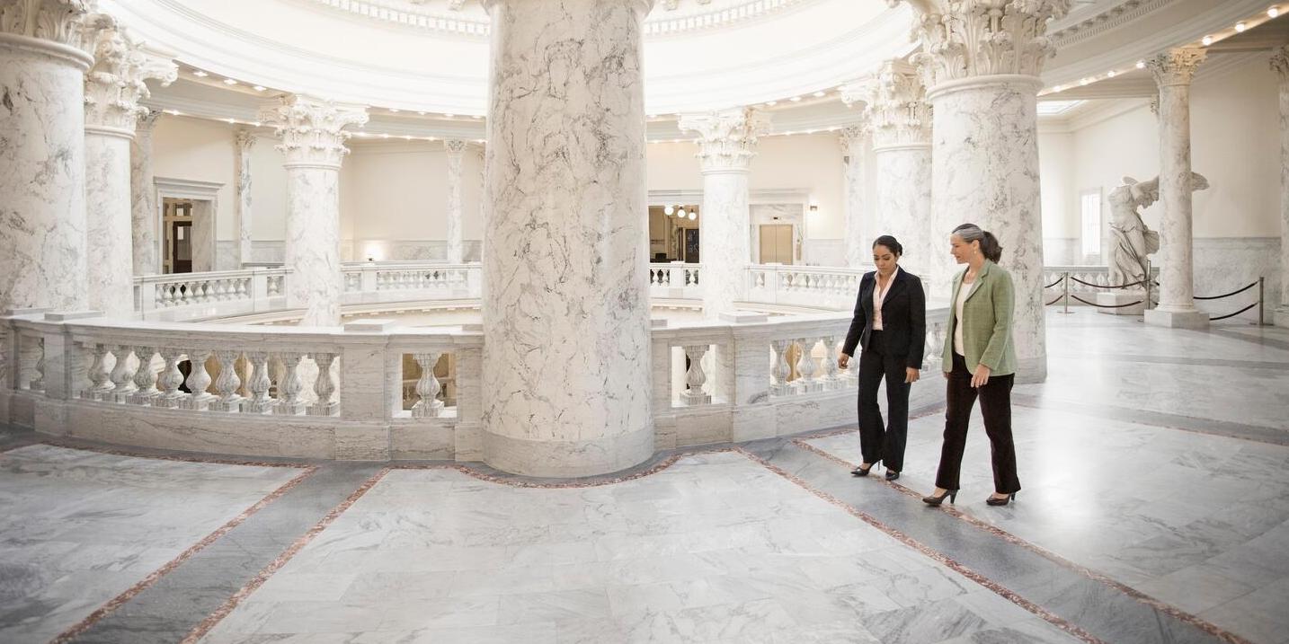 Two businesswomen talking in a government building