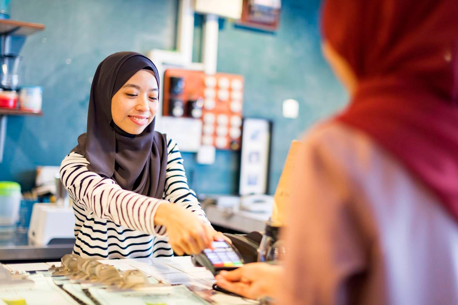 Malaysian woman paying with credit card