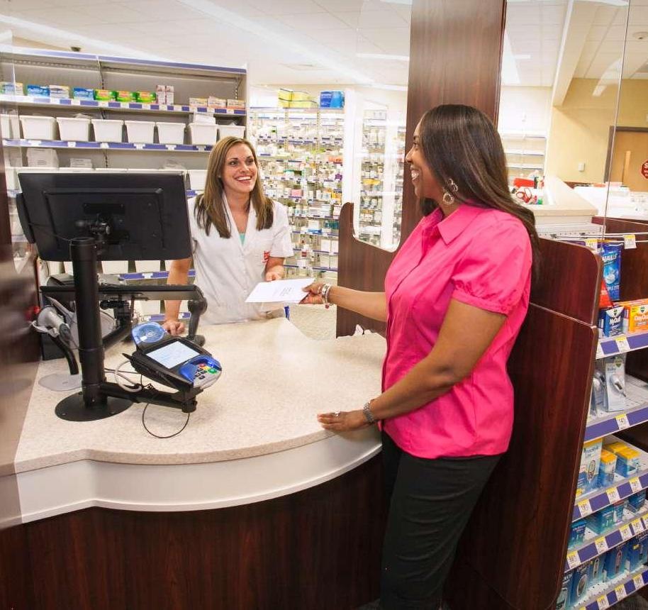 Woman picking up prescription at SAS Pharmacy counter