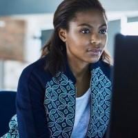 Black Woman working behind a computer in the office