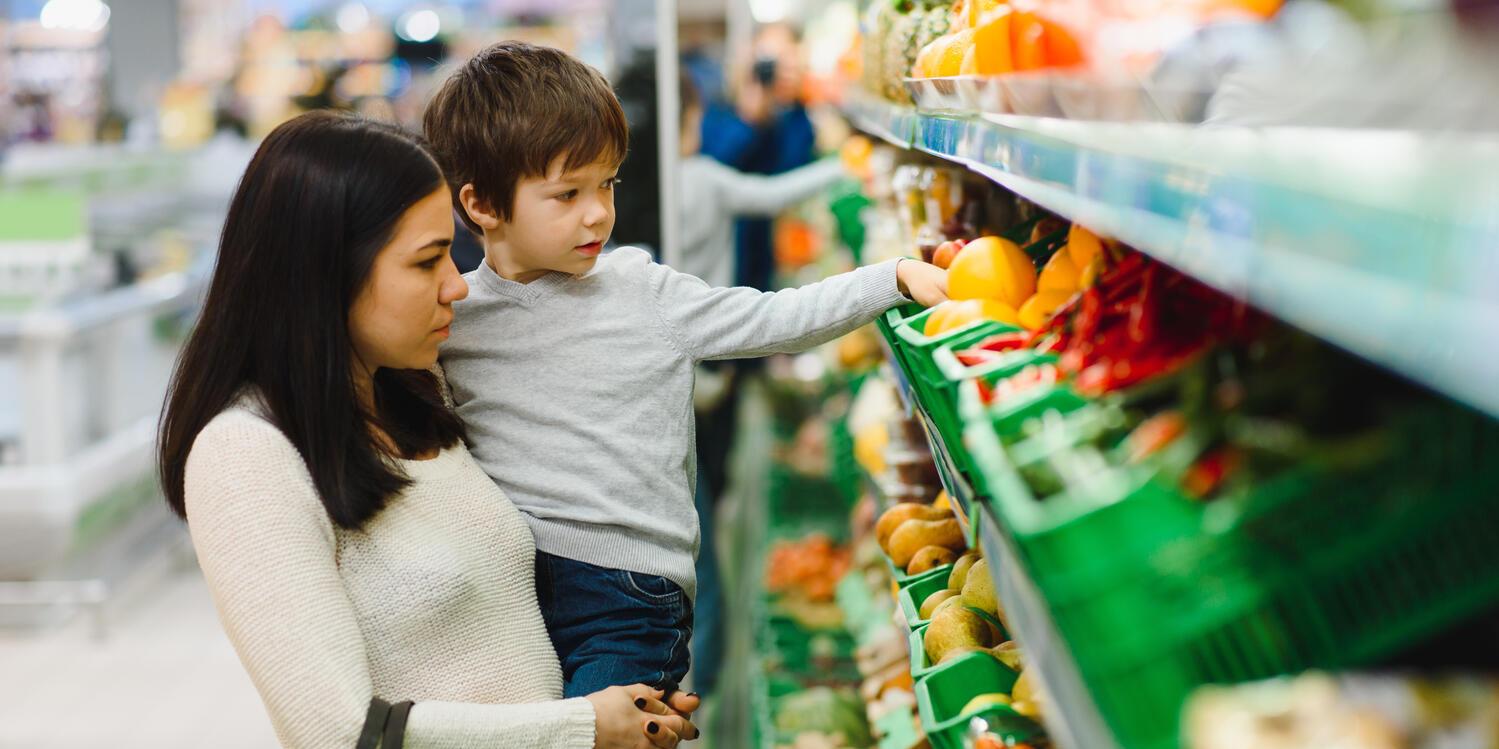 Mother shopping in supermarket with son