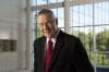 Portrait of Jim Goodnight in front of wall windows