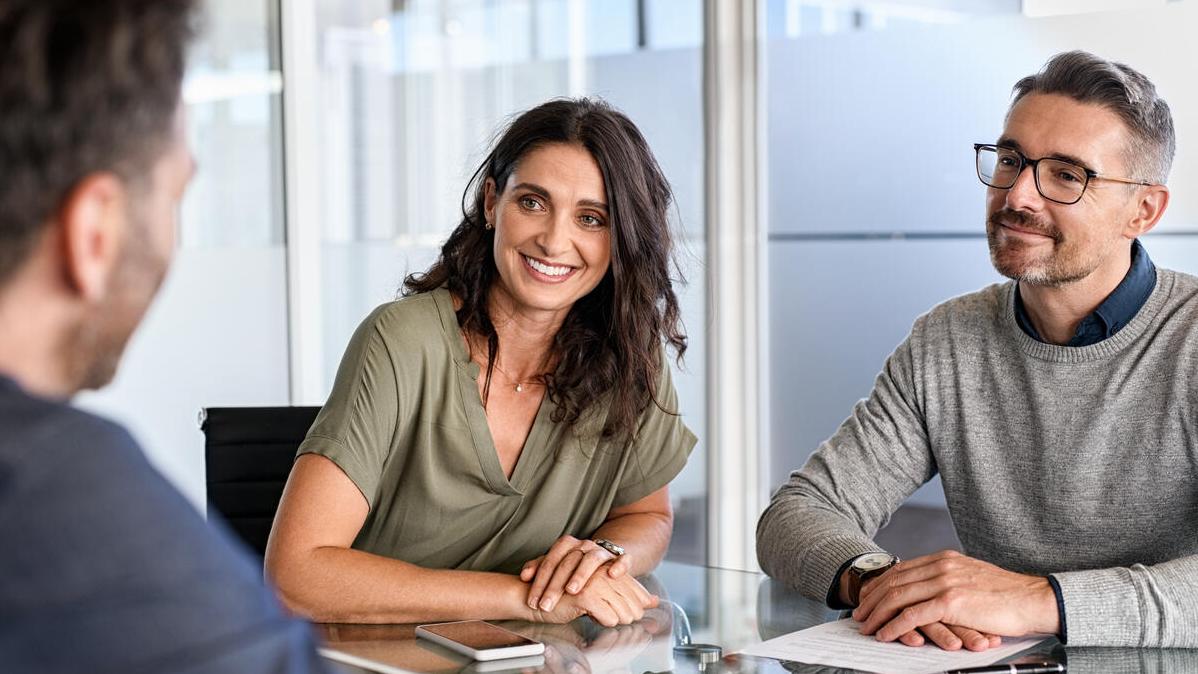 couple meeting with an insurance agent giving advice