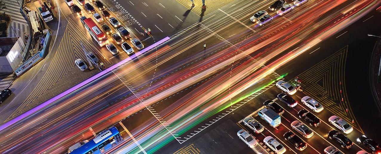 cars at busy intersection at night