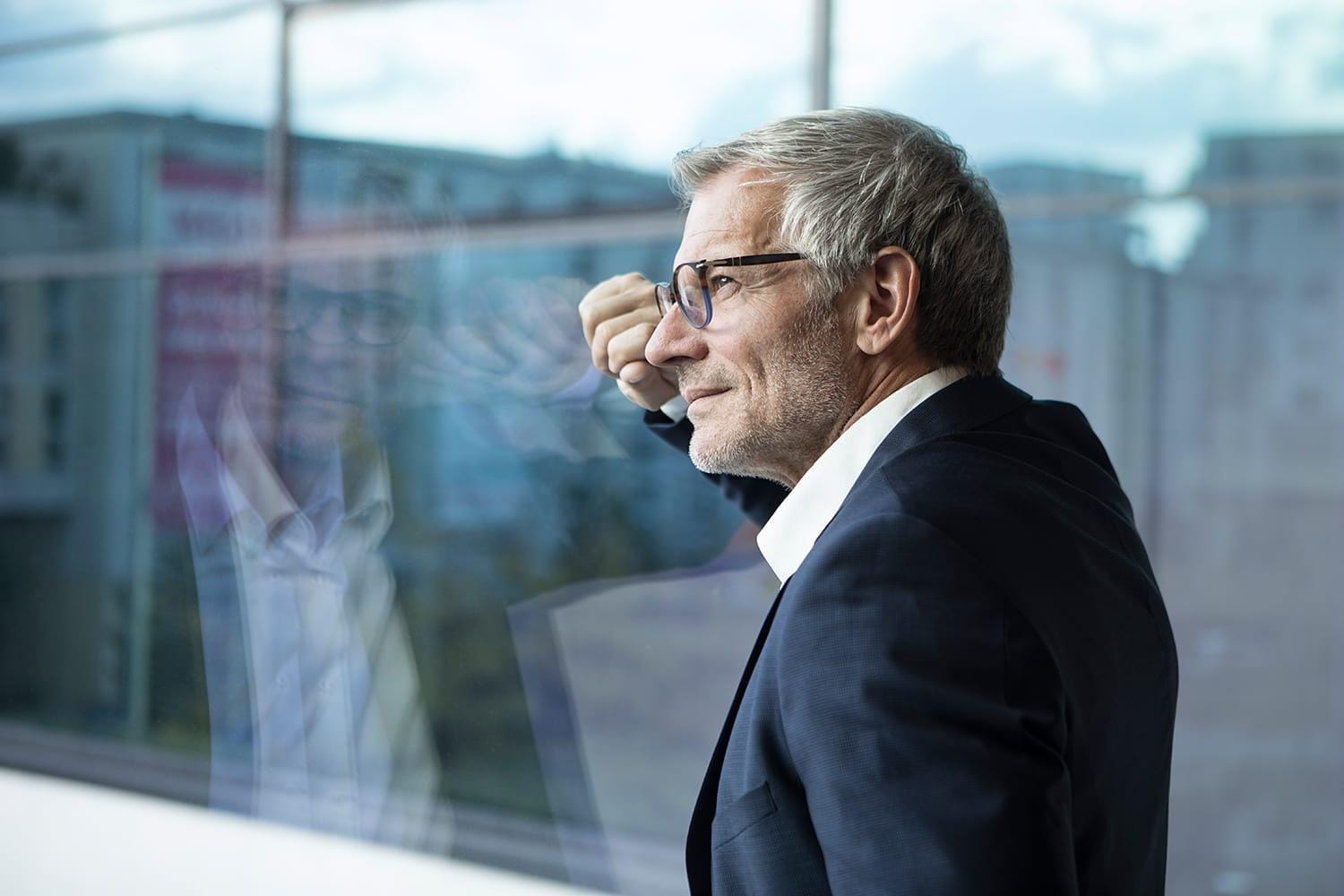 Confident businessman looking out of window