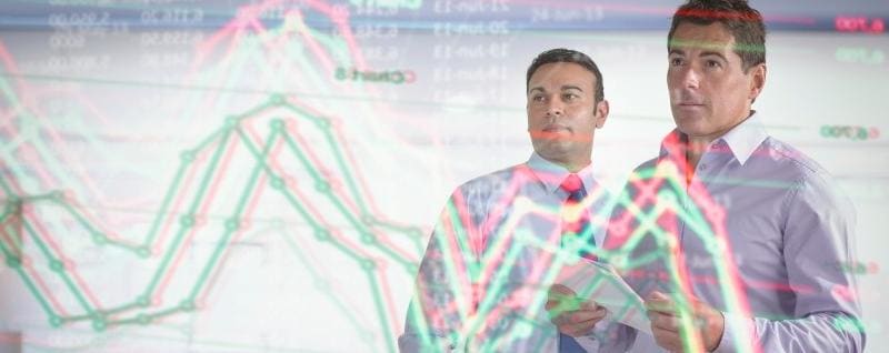 Two businessmen looking at futuristic wall display