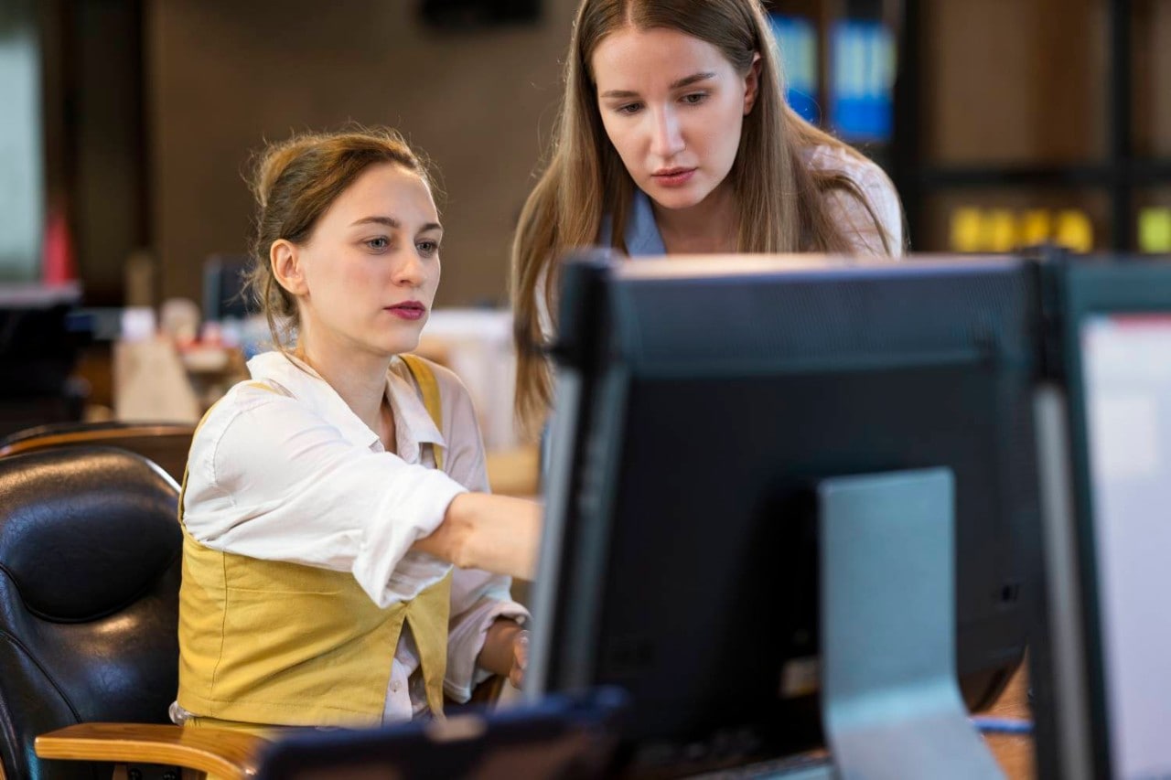 Women pointing at computer screen