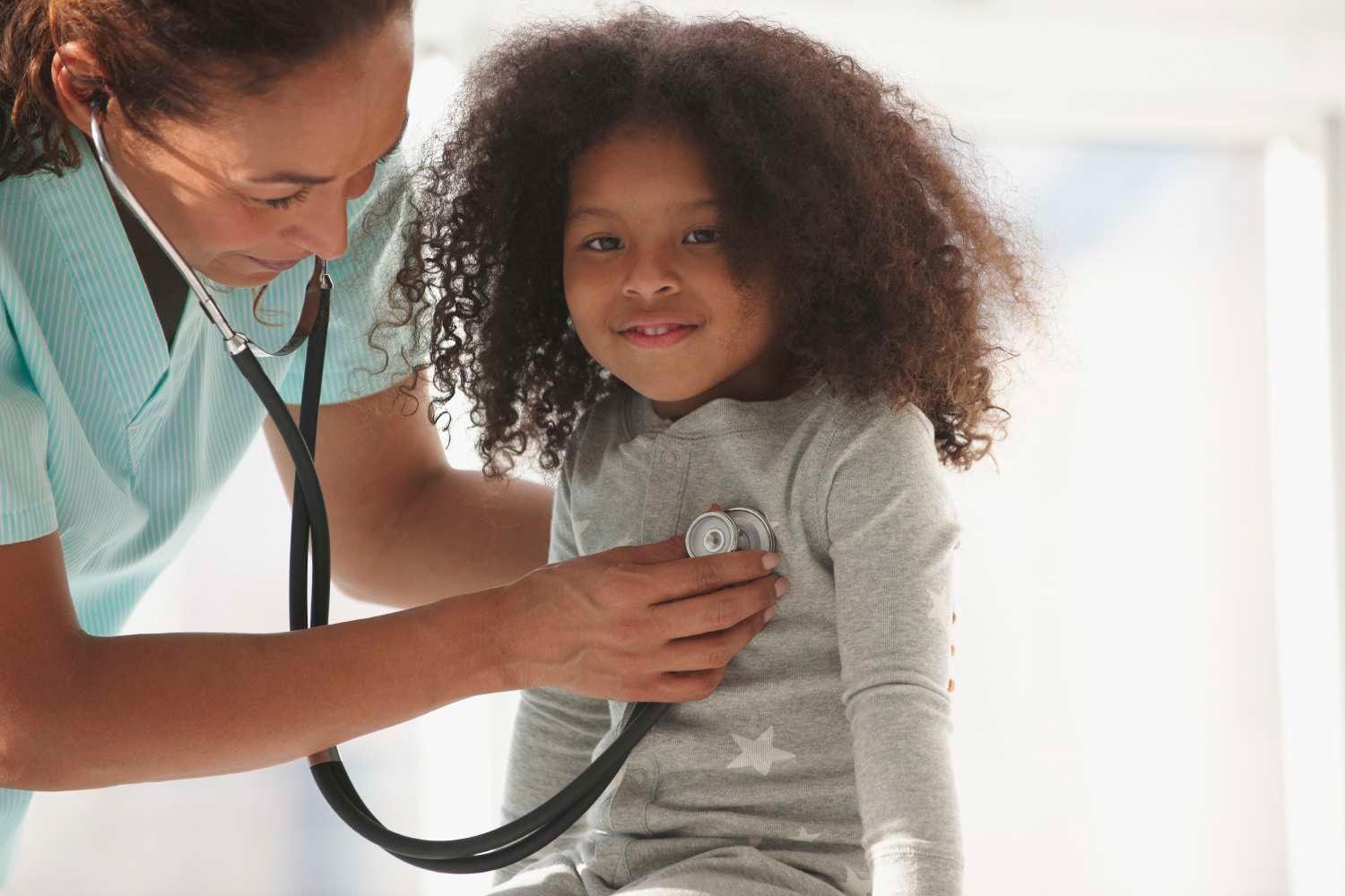 Female Doctor examining a child with stethoscope