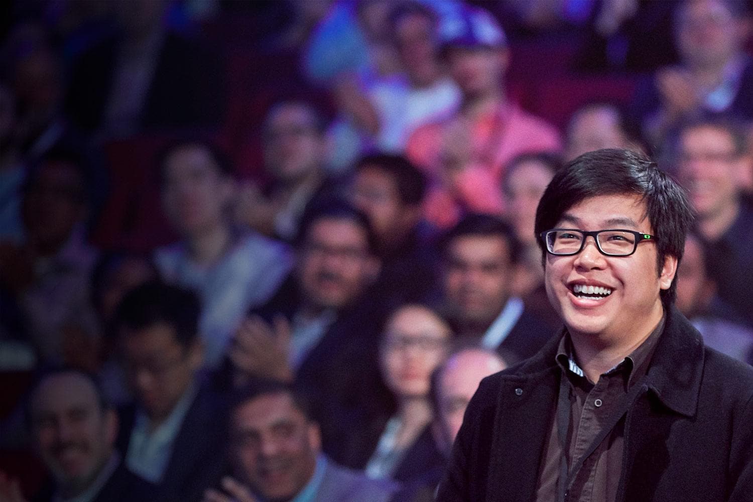 Happy asian man in conference audience