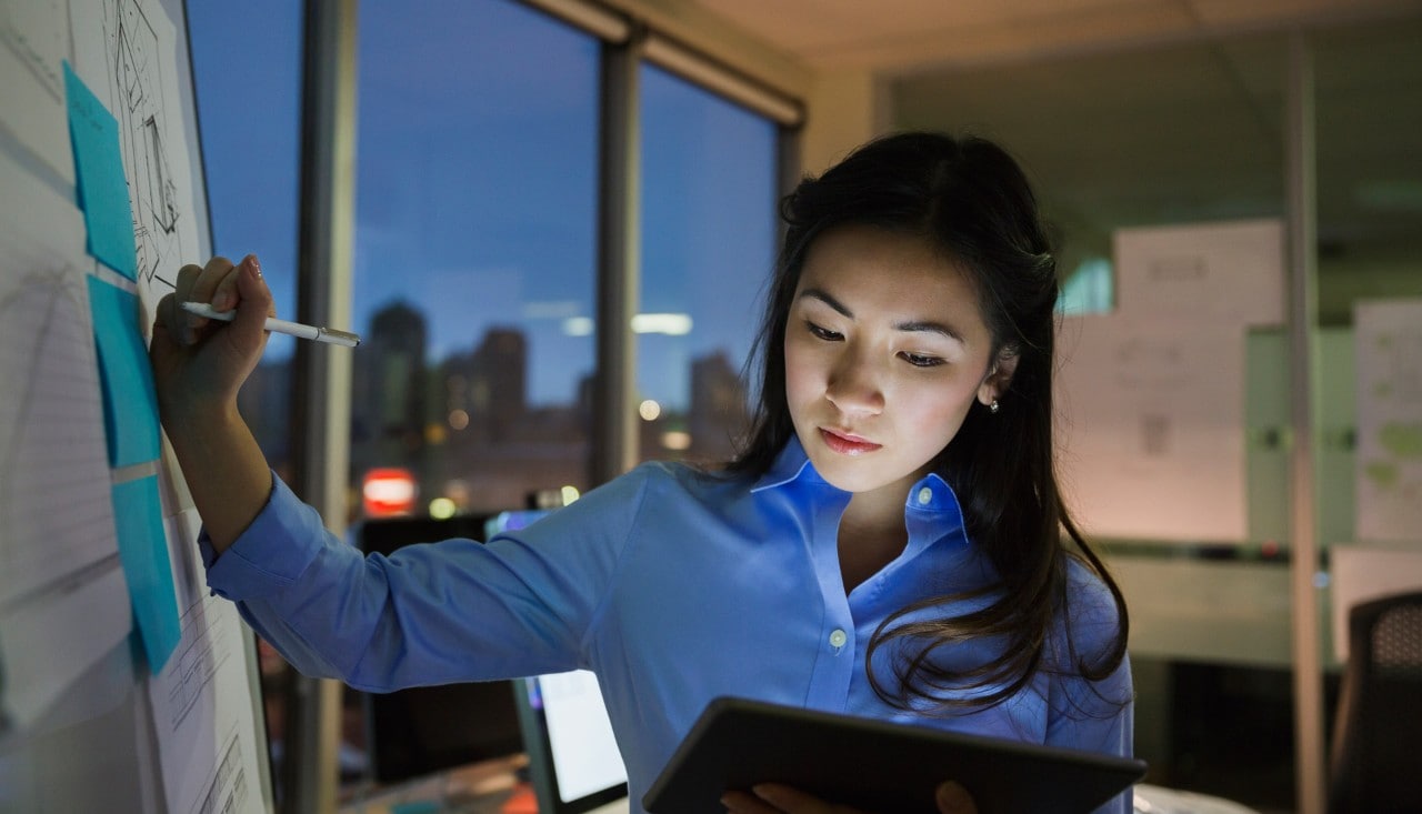 Asian woman working late