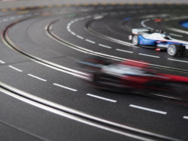 Blue and red toy cars racing on a track