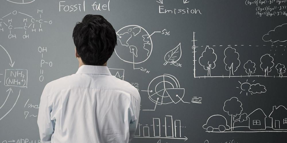 Data scientist at chalkboard solving fossil fuel problems