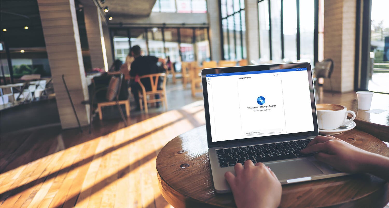 Man holding glasses and looking upward