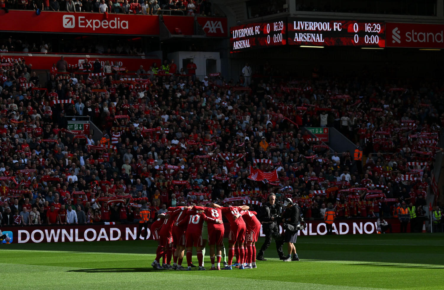 Liverpool F.C. players huddle on the field