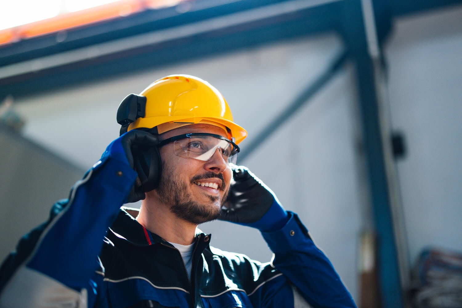 Smiling worker wearing safety helmet