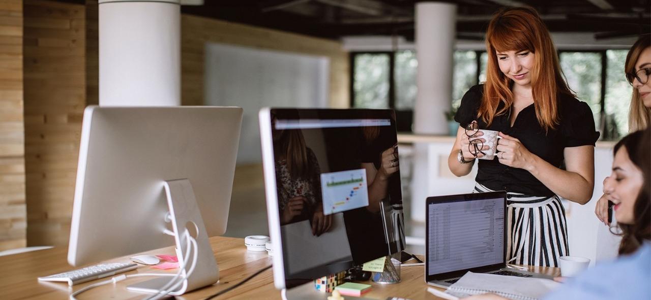 Use and optimize your software Woman learning from instructor and smiling