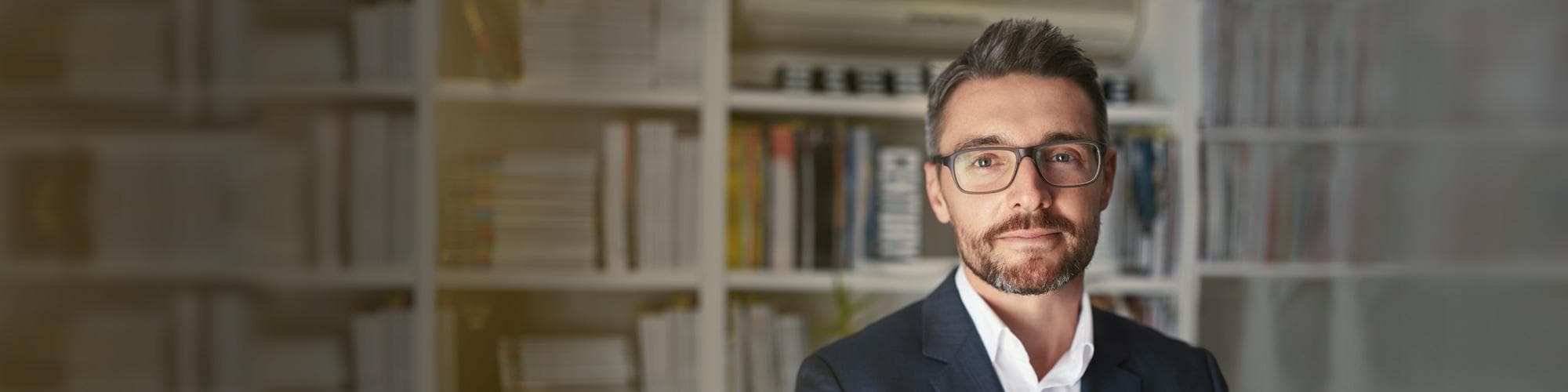 Businessman wearing glasses standing in office