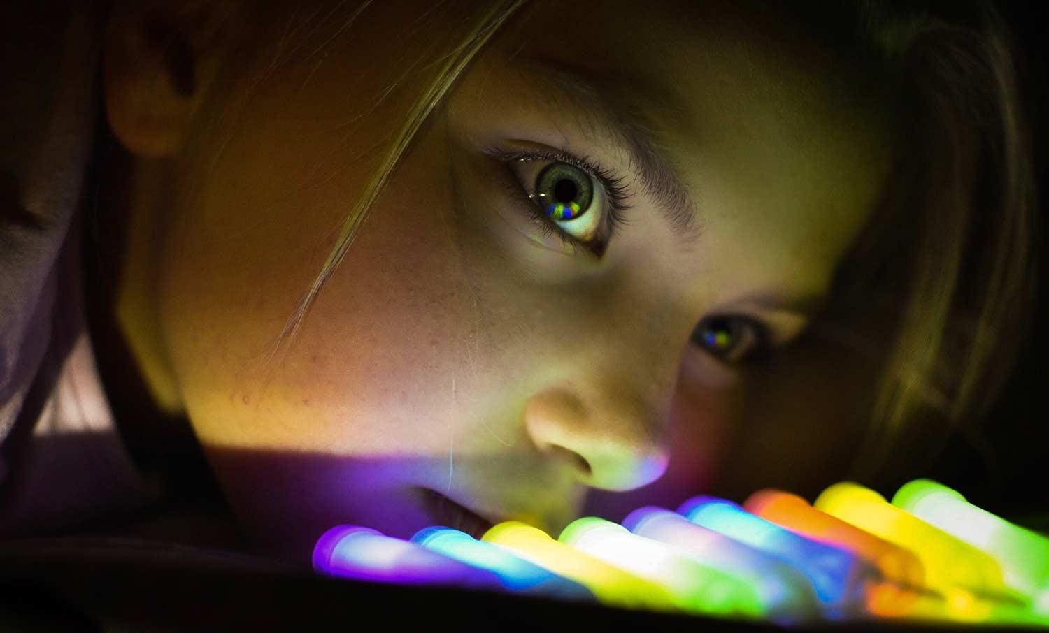 Girl looking up with light in her eyes and nose