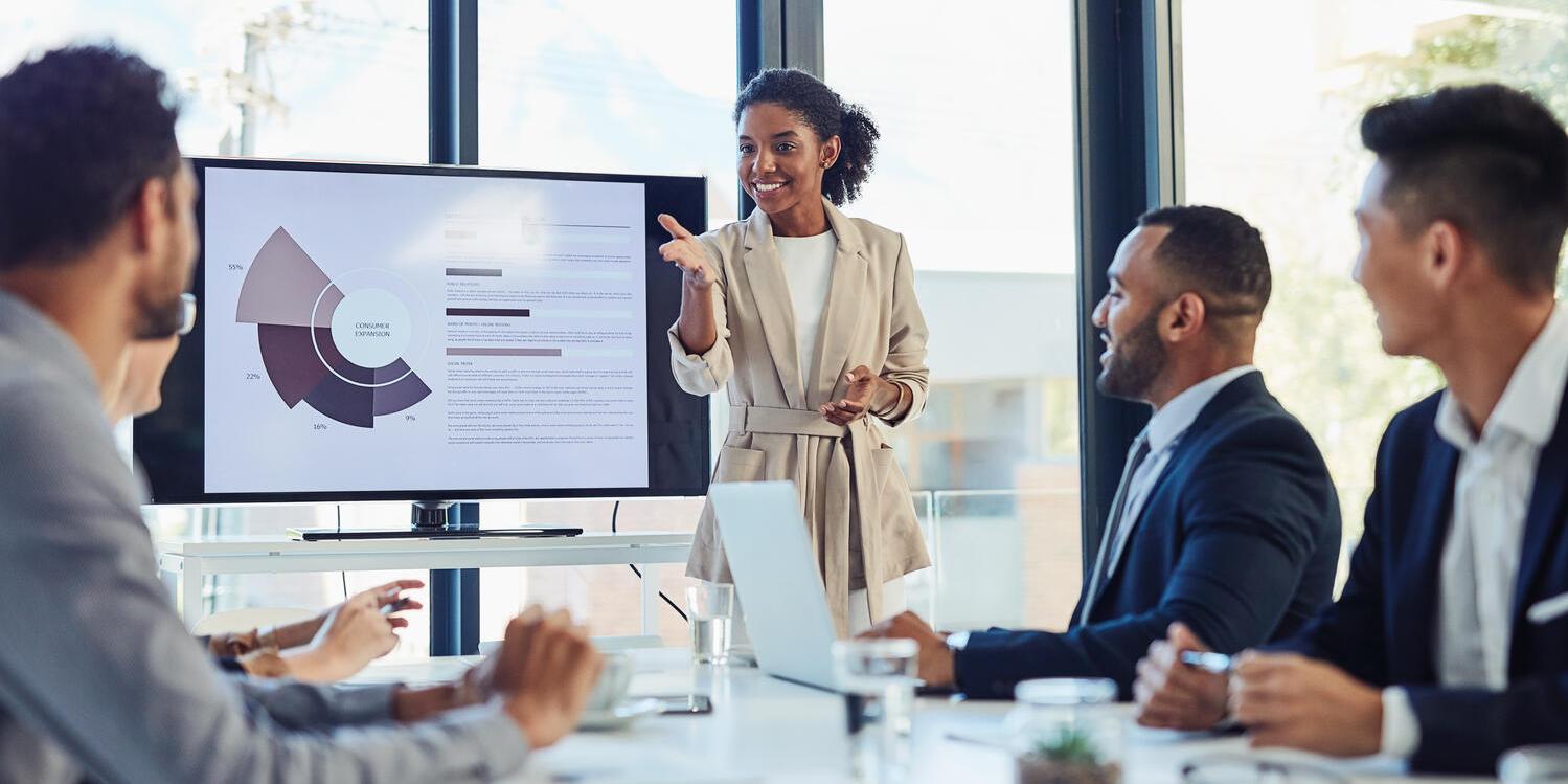Businesswoman presenting in boardroom with colleagues