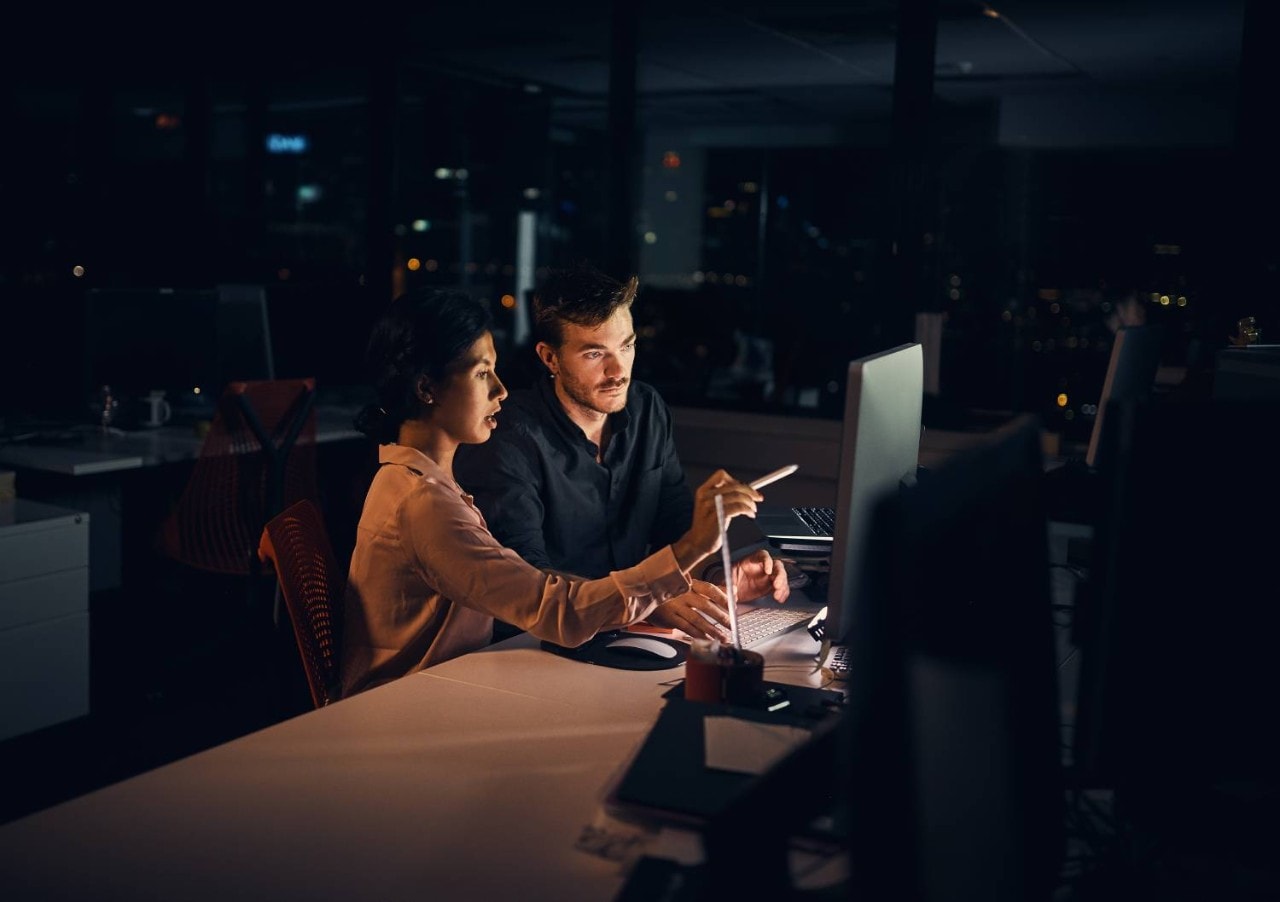 photo of coworkers working together at a desktop computer