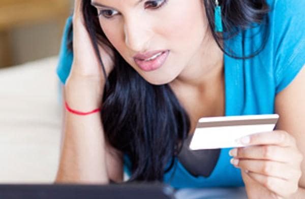 worried woman holding credit card worried woman holding credit card