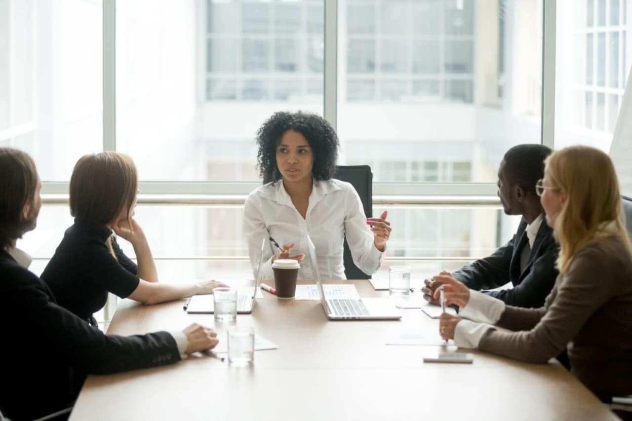Woman leading meeting in conference room