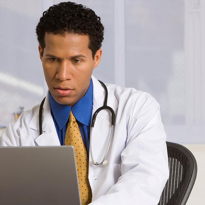 Doctor looking at data on the screen of laptop