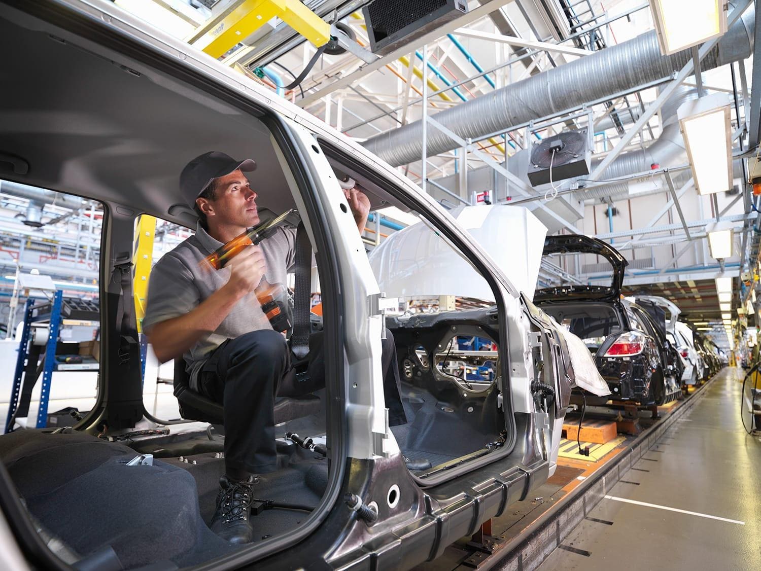 Car plant worker on production line
