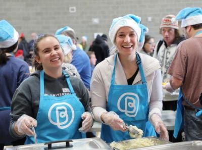 Bissell Centre Staff Serving Food while Smiling