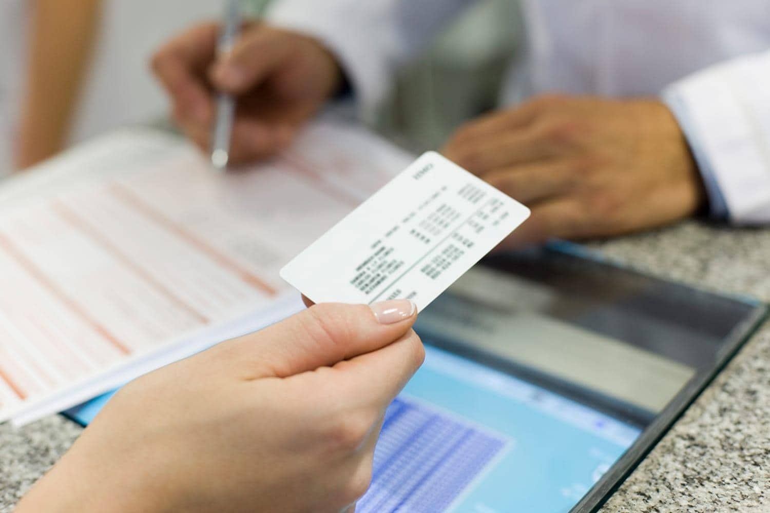 Patient using health insurance card