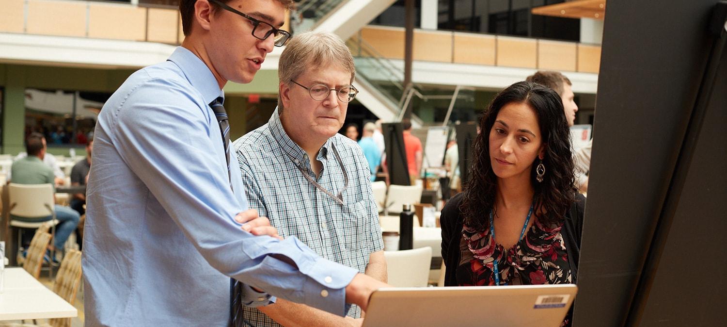 SAS intern presenting work to two employees